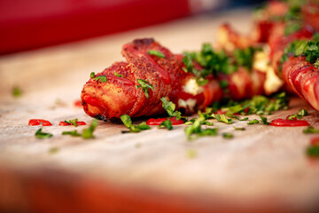 Sweet red pepper stuffed with cream cheese, wrapped in bacon and grilled
