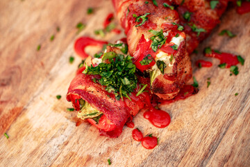 Sweet red pepper stuffed with cream cheese, wrapped in bacon and grilled