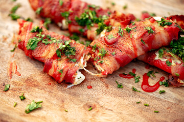 Sweet red pepper stuffed with cream cheese, wrapped in bacon and grilled