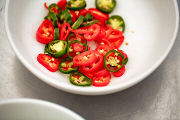 Bowl of sliced chilli peppers - red and green