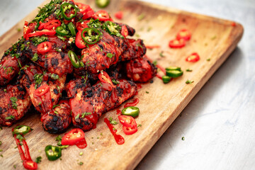 Chicken wing platter with sriracha sauce and fresh chillis