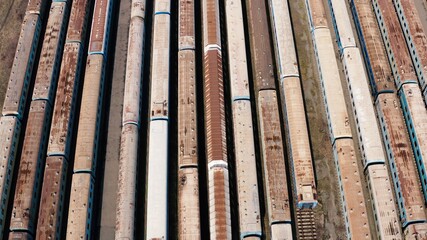 Railway hub showing passenger old crusty trains on tracks next to each other top down view drone moving slowly showing railway tracks positioned parallel. Old Railway Carriages and Wagons 4k 