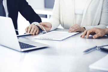 Business people discussing contract working together at meeting in modern office. Unknown businessman and woman with colleagues or lawyers at negotiation