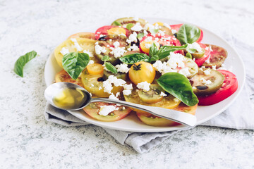 Tomato salad with basil, feta cheese and olive oil