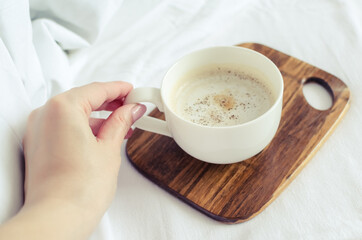 A cup of coffee in hand
