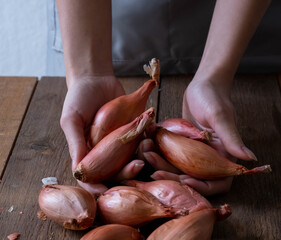 Fresh raw onions on wooden background.