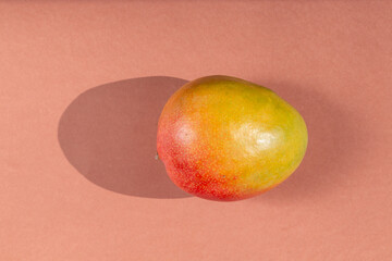 Fresh delicious mango isolated on brown background
