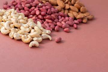 group of nuts on brown background, healthy food concept, empty space for text
