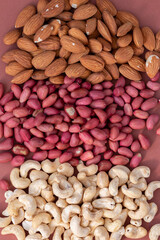 group of nuts on brown background, healthy food concept, empty space for text
