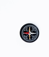 A magnetical compass on a white table..