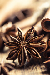 Detail of star anize and cinnamon sticks on a vintage wooden surface