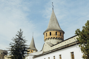 Spire of the old castle against the blue sky. Kamianets Podilskyi, Ukraine