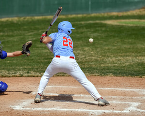 Action photo of high school baseball players making amazing plays during a baseball game