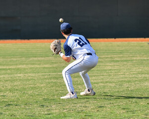 Action photo of high school baseball players making amazing plays during a baseball game