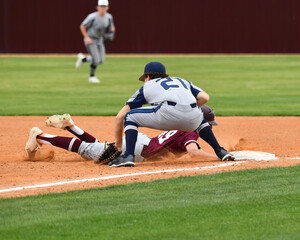 Action photo of high school baseball players making amazing plays during a baseball game