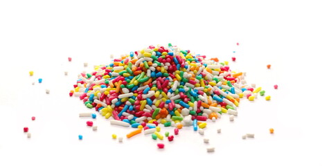 Pile colorful candy sprinkles isolated on white background, side view