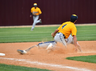 Action photo of high school baseball players making amazing plays during a baseball game