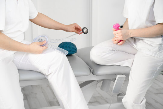 Team of physiotherapists practicing exercises for helping patients. High quality photo
