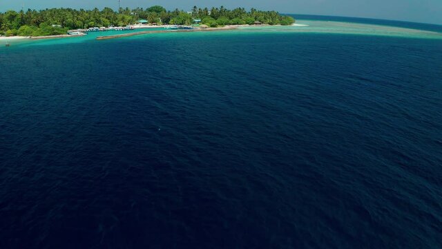 Aerial view of a tropical island in the Indian Ocean. Thinadhoo (Vaavu Atoll), Maldives