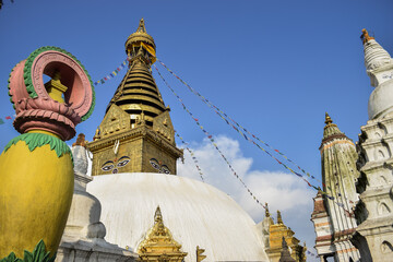 Swayambhunath stupa and buildings surrouding it in contrast with the blue sky. Kathmandu, Nepal.