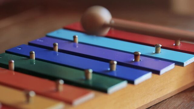 Mallet Striking a Multicolor Wooden Xylophone Close-Up in 4K