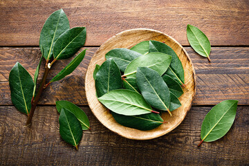 Green bay leaves on wooden background. Laurel leaf. Bay laurel leaves