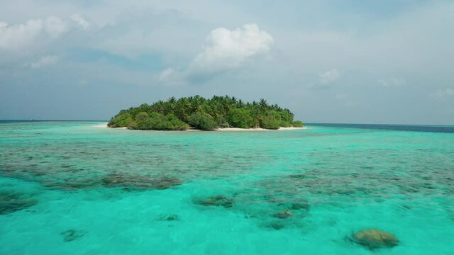 Aerial view of a tropical island in the Indian Ocean. Thinadhoo (Vaavu Atoll), Maldives