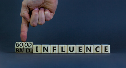 Good or bad influence symbol. Businessman turns cubes and changes words 'bad influence' to 'good...