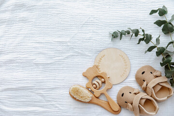 Newborn booties with empty card and wooden toys. Baby Background, top view, flat lay, copy space - 423839602