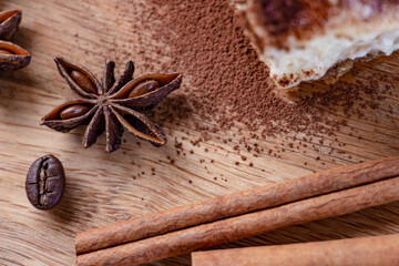 beautiful composition of anise, brown sugar, cinnamon and coffee beans on a wooden background