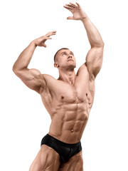 A man with a perfect physique is posing. Classic bodybuilding. Competitive season. Isolated on...