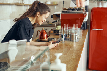 Barista taking order from customer online on smartphone. Concept of cafe and coffee shop small business