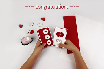 Cute 5-6 years old girl making DIY card with colored paper for her mom in Mothers Day, decorative...