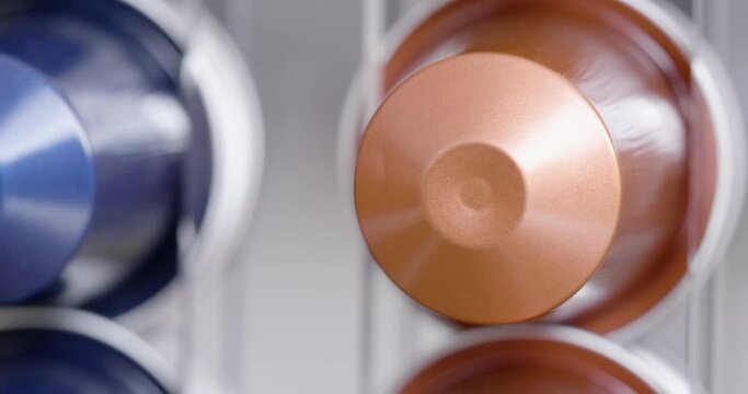 Aluminum coffee capsules in tracking shot