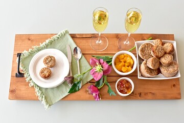 Simple breakfast brunch pastry muffins and champagne for  Mother's Day morning in bed or romantic holiday weekend. Photo concept food background, close-up, copy space