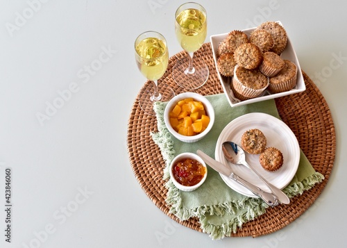 Simple breakfast brunch pastry muffins and champagne for  Mother's Day morning in bed or romantic holiday weekend. Photo concept food background, close-up, copy space