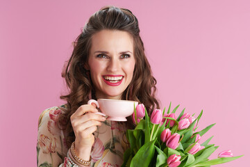 happy trendy woman with long wavy brunette hair on pink