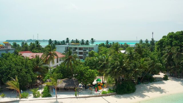Drone view of a tropical island with a hotel and residential property. Thinadhoo (Vaavu Atoll), Maldives