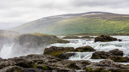 Detail of the majestic Godafoss waterfall near the city of Akureyri during summer season