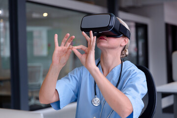 Caucasian female doctor wearing scrubs using vr headset and virtual interface