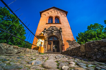 Fototapeta premium Grodno Castle surrounded by greenery under the sunlight and a blue sky in Zagorze, Poland