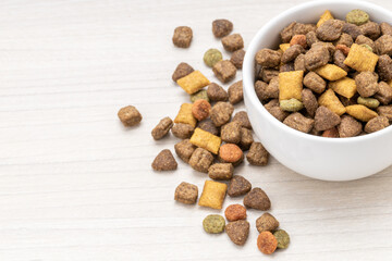 domestic pet dry food on wooden background. dried cat feed. above view