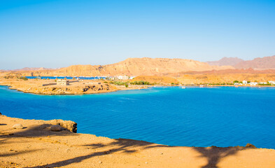 Fototapeta premium beautiful panoramic views of Sharm El Maya Bay, Hadaba in Sharm El Sheikh, Egypt, South Sinai, with clear blue sea and sun-drenched cliffs