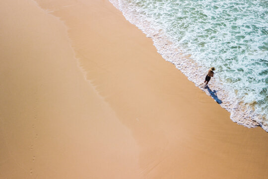man fishing on the beach