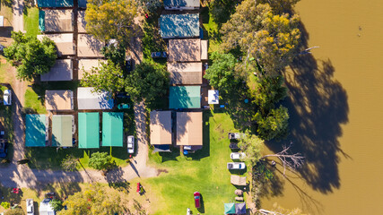 Aerial view caravan park sites on the shores of a river