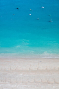 Aerial image of turquoise water and boats at Gantheaume Point
