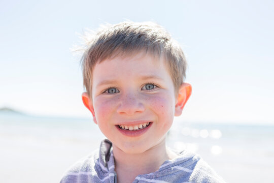 Young boy at the beach smiling