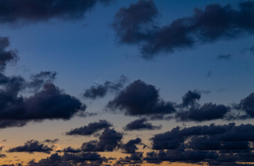 Dark clouds during sunset. Sunset full of gray clouds
