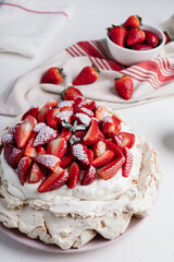 Delicious Pavlova cake dessert with fresh strawberry. White and red dessert