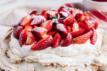 Delicious Pavlova cake dessert with fresh strawberry. White and red dessert